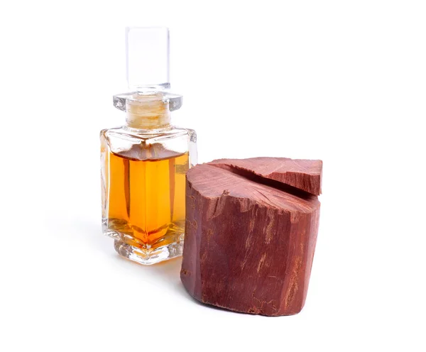 Chandan or red sandalwood piece isolated on white baclground. With essential oil — Stock Photo, Image