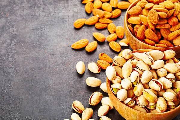 Pistachios Almonds Wooden Bowls Standing Rustic Background — Stock Photo, Image