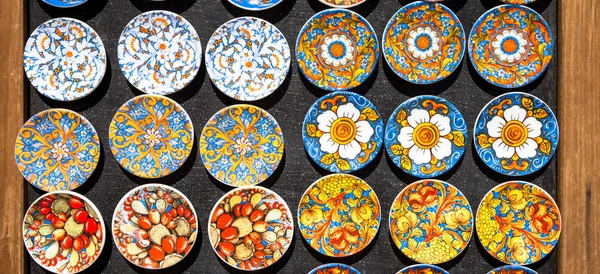 Souvenir from Sicily: fridge magnets with colourful design. Useful for background.