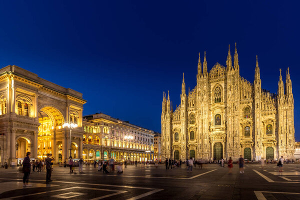 MILAN, ITALY - APRIL 28th, 2018: turists during blue hour taking pictures in Duomo Square , the main landmark of the city.