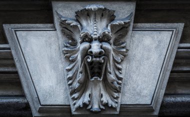 Italy, Turin. This city is famous to be a corner of two global magical triangles. This is a protective mask of stone on the top of a luxury palace entrance, dated around 1800 clipart