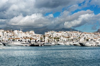 Marbella, İspanya - 13 Ekim 2016: Bulutlu bir sonbahar sabahı Costa del Sol 'da Puerto Jose Banus marinasında demirlemiş beyaz pahalı yatlar,