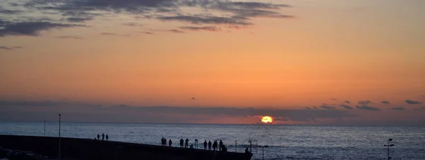 stock image People watching the sunset on Atlantic Ocean shore