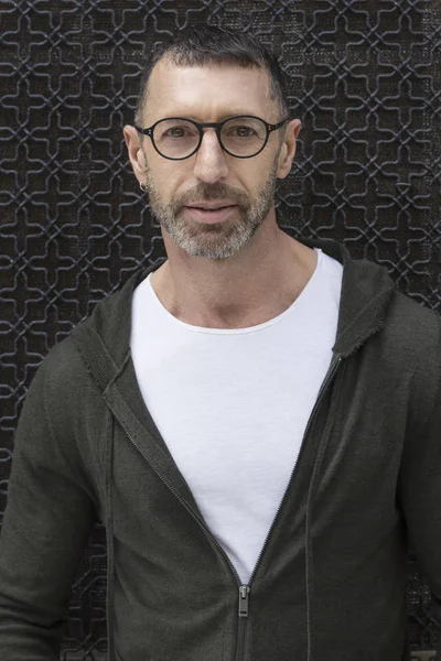 Sokak moda kavramı. Zarif genç yakışıklı adam portresi. Arka plan olarak Paris binalar.