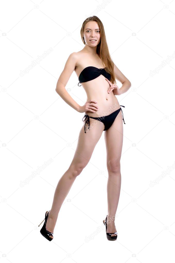 Model tests. Beautiful sexy girl with long hair in a black swims