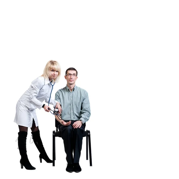 Female doctor in a white coat measures pressure to a man sitting on a chair, on a white background, isolated