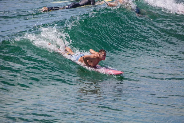 surfer riding the waves at pacific beach