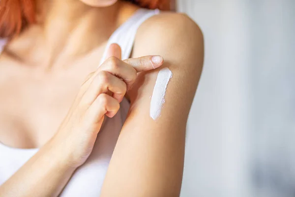 Woman applying hand cream - stock photo — Stock Photo, Image