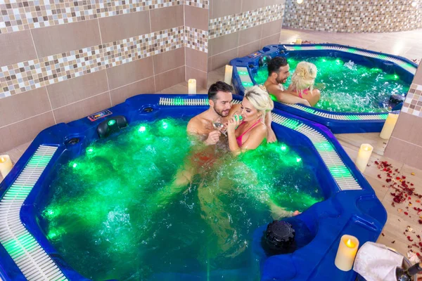 Fim de semana preguiçoso para dois - Casal relaxante em jacuzzi no spa de saúde — Fotografia de Stock