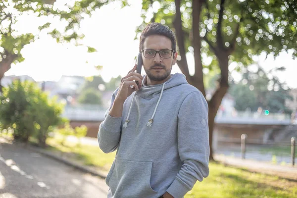 Smart Aussehender Mann Spricht Mit Smartphone Park Outdoor Shooting Gegenlicht — Stockfoto