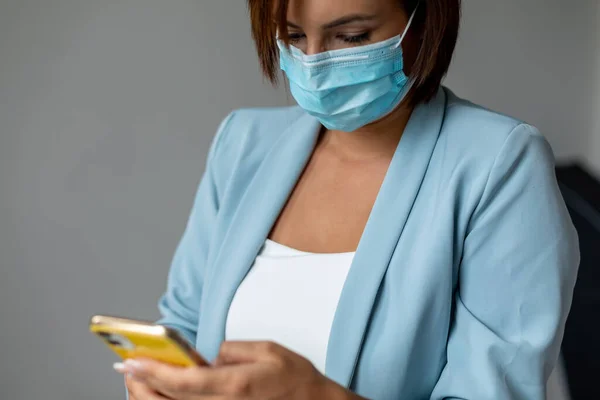 Donna Con Maschera Facciale Utilizzando Smartphone Indoor — Foto Stock