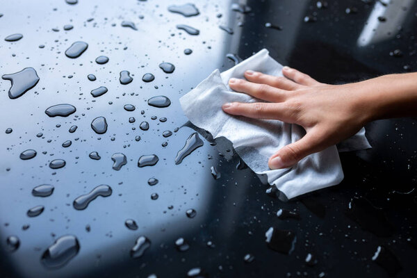 Woman hand clean cleaning liquid water drops with wipe or tissues