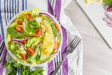 Elma dilim masa üzerinde beyaz seramik kase lezzetli sebze salatası.