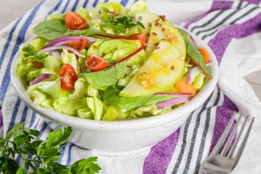 Elma dilim masa üzerinde beyaz seramik kase lezzetli sebze salatası.