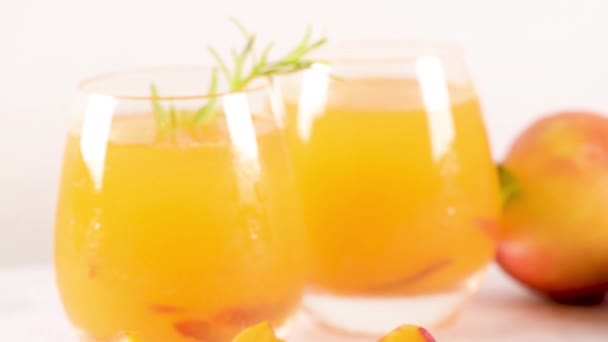 Homemade Peach Juice Ice Cubes Rosemary Leaves Glass Marble Stone — Stock Video