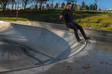 kaykaycı yerel skatepark günbatımında Grind'de üzerinde.