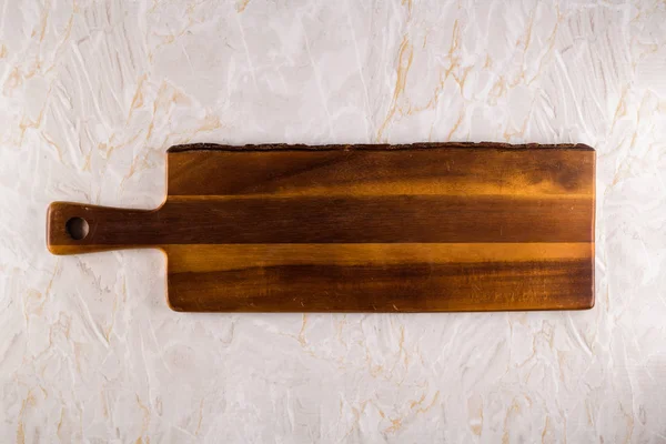 Tabla de cortar de madera sobre un fondo de mármol gris — Foto de Stock