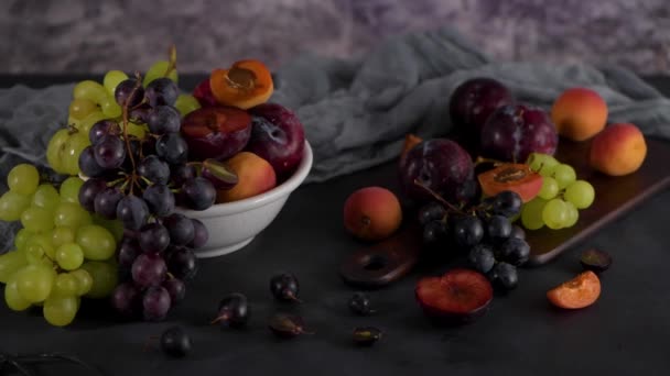 Fruchtstillleben Mit Früchten Auf Weißer Keramikschale Betonmauer Dramatisches Licht Trauben — Stockvideo