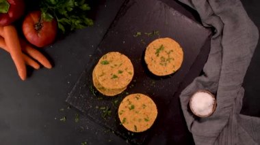 Çiğ vejetaryen burger ve nohut ve maydanoz yapraklı sebze mutfak tezgahında..