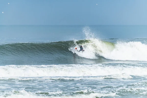 Bodyboarder surfing ocean wave