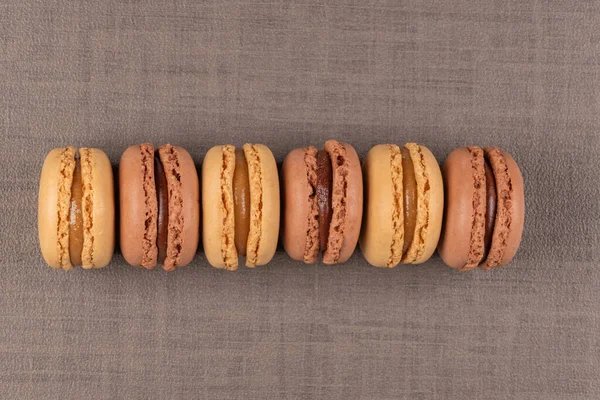 Six Coffee Chocolated Flavoured Macaroons Brown Vinyl Background — Stock Photo, Image