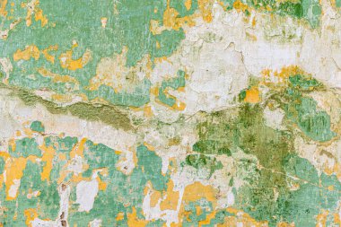Soyulmuş yeşil boyalı eski bir duvar. Eski desenli beton duvar yeşile boyanmış.