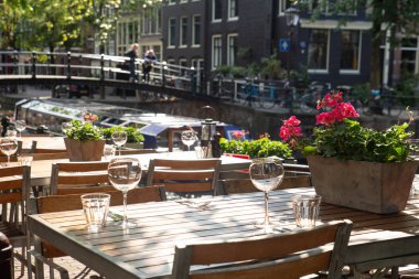 Amsterdam Restoran Cafe tablolar için cam ve arka planda Kanal Köprüsü manzaralı yemek açık ayarla