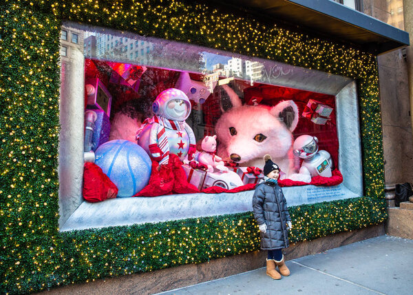 NEW YORK CITY - DECEMBER 7, 2018: Christmas in New York street scene from Macy's Department Store at Herald Square in Manhattan with holiday window displays and people.