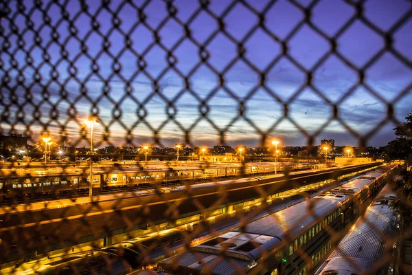 ニューヨーク市マンハッタン鉄道ヤードから見たチェーン リンクの塀を通して見た多くの列車 — ストック写真