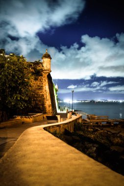 Beautiful El Morro fortress in Old San Juan Puerto Rico seen at night from along Paseo Del Morro clipart