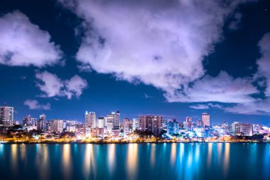 Beautiful Condado Beach, San Juan Puerto Rico seen at night with bay, buildings and lights clipart