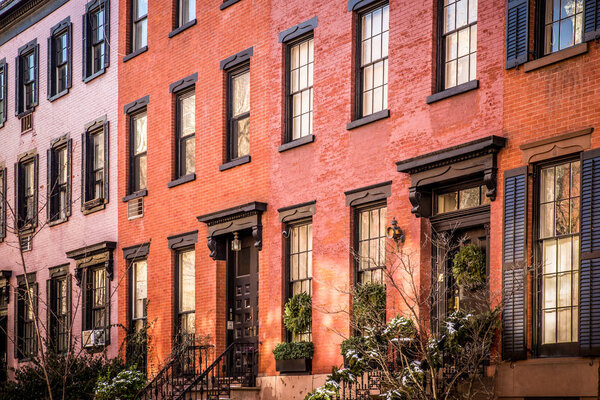 Row of lovely brick and brownstone New York City apartments seen from outside.