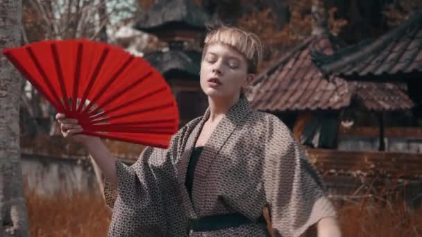 Menina Moda Bonita Quimono Com Ventilador Mão Vermelha Posando Livre — Vídeo de Stock