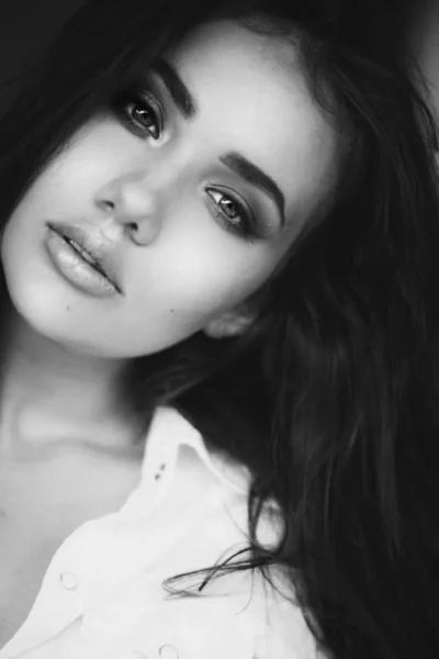 Closeup face of woman with amazing eyes. Fashion beauty black and white portrait of attractive girl