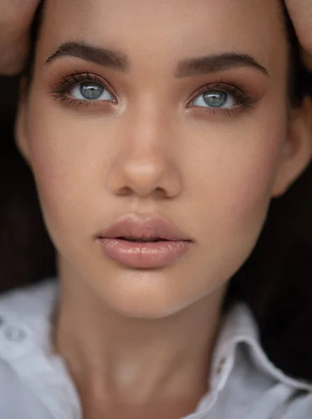 Closeup face of woman with amazing eyes. Fashion beauty portrait of attractive girl