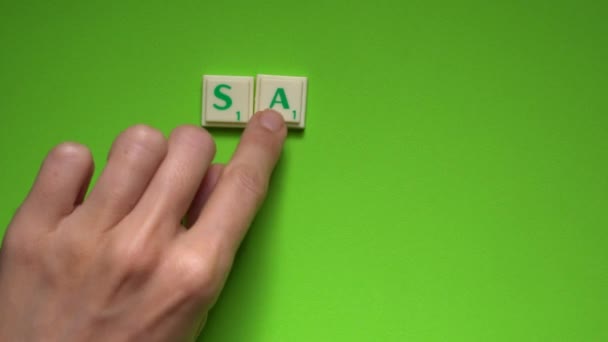 女性の手のグリーン スクリーンの背景に文字で 安全な家 作成の言葉 — ストック動画