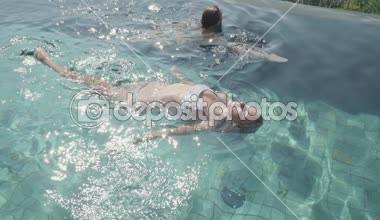 Genç Güzel kadınlar yüzme, - ağır çekimde video açık yüzme havuzunda rahatlatıcı bikini