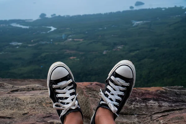 Closeup shoes over beautiful valley landscape. Traveling, freedom and lifestyle concept