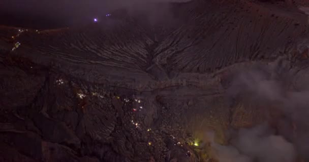 日の出時に酸湖で美しいイジェン火山を歩く人々の空中ドローンハイパーラプスビュー インドネシア — ストック動画