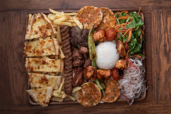 Mixed turkish kebab plate isolated on wooden background