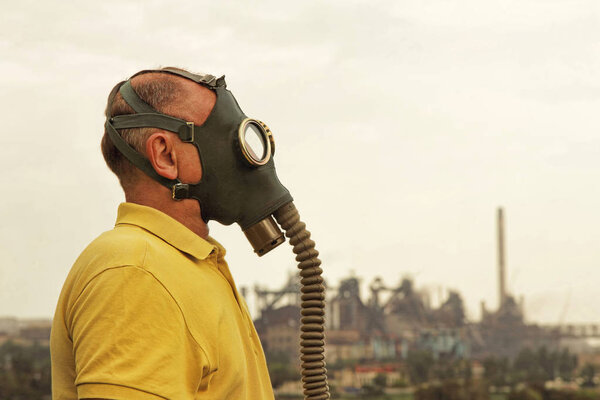 Men in gas mask. View of the industrial factory.