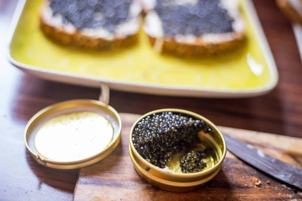 A Jar with Black Caviar on the Wooden Background, Preparing Sand Stock Photo