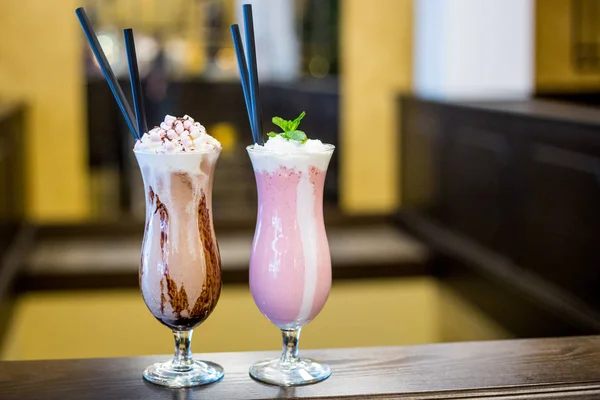 Strawberry and Chocolate Milkshakes with Whipped Cream and Marsh Royalty Free Stock Photos