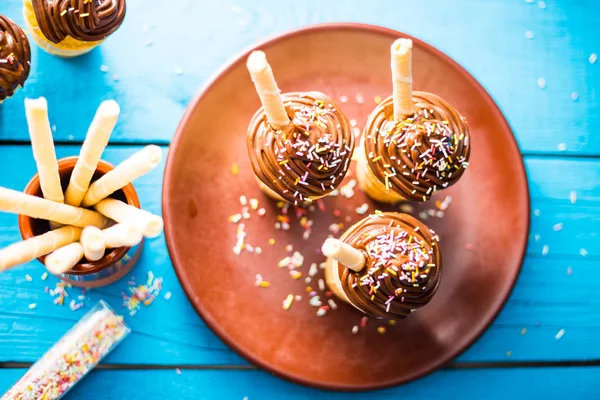 Vanilla Chocolate Cupcakes in Waffle Cup on Blue Background Stock Picture