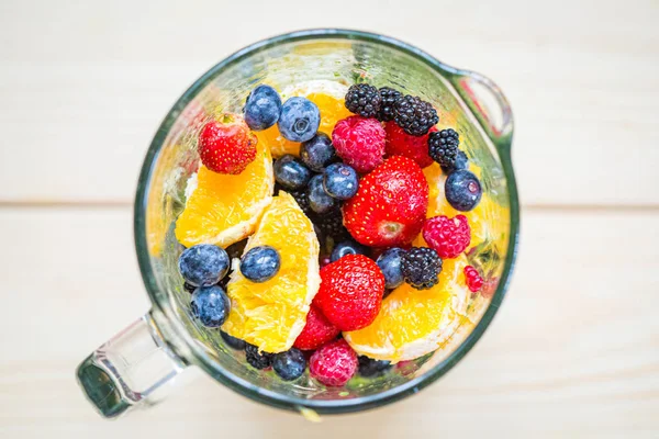 Mixed Berries with Spinach and Orange in a Blender, Smoothie Pre Stock Photo