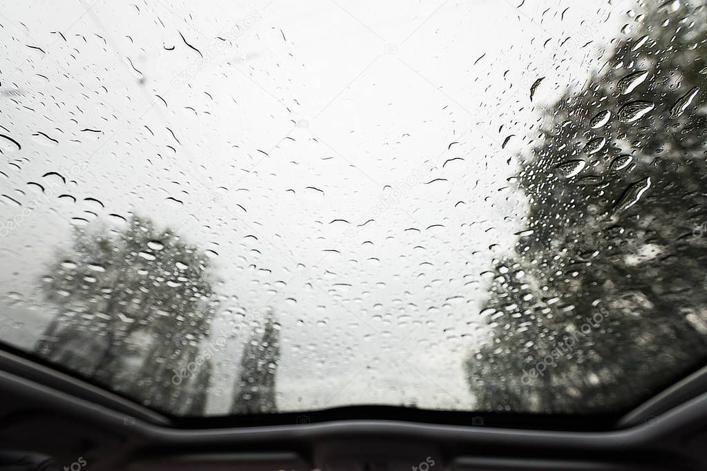 Look through windshield from inside the car at rainy weather