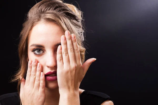 Beautiful model with makeup closing her face — Stock Photo, Image