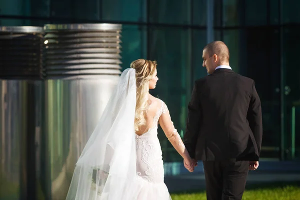 Mutlu gelin ve damat yakındaki modern Binası yürüme — Stok fotoğraf