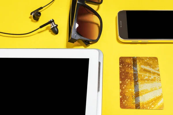 electronic devices and accessories on a yellow background