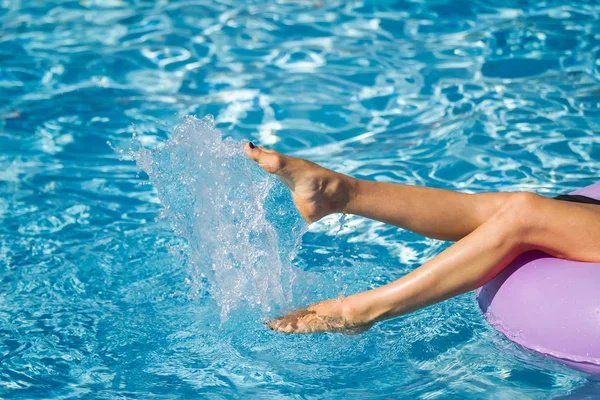 Γυναίκα πόδια παίζουν με το νερό στην πισίνα — Φωτογραφία Αρχείου